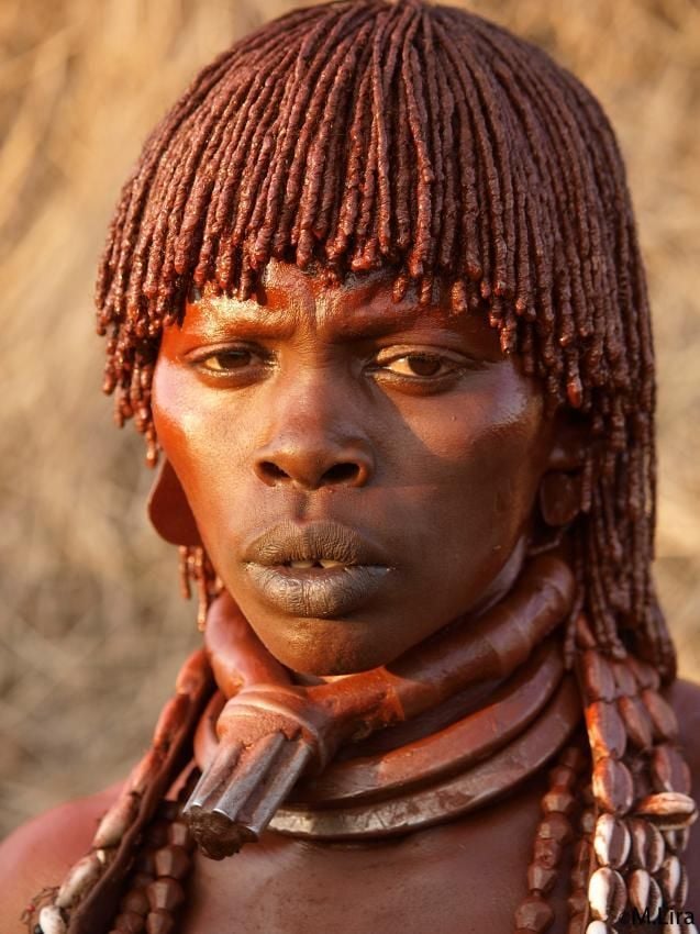 Hamar woman — ochre-braided hair and traditional beads